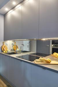 a kitchen with white cabinets and a counter top at Rydygiera 16-18 by Homeprime in Warsaw