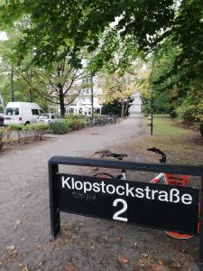 a sign in a park with a bike parked next to it at Oase im Park in Berlin