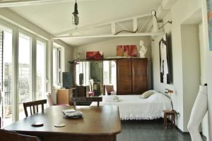 a bedroom with a bed and a table and chairs at Mini Attico panoramico con terrazza in Cagliari