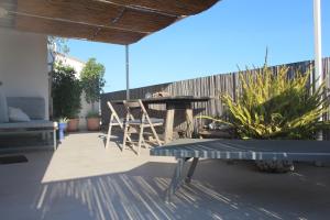 a patio with a table and chairs and a fence at Mini Attico panoramico con terrazza in Cagliari