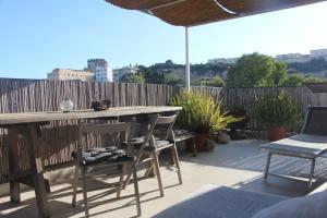 a patio with a table and chairs and a fence at Mini Attico panoramico con terrazza in Cagliari
