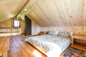 a bedroom with a bed in a wooden room at Vip Forest dreams villa in Anykščiai