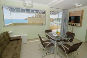 a living room with a glass table and a couch at VIDA MANSA in Bombinhas