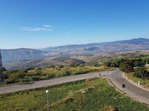 a road with a person riding a bike on the road at La tua casa vicino Matera in Grassano
