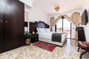 a bedroom with a bed and a large window at VILLA ILYANA in Marrakesh +35 photos