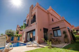 a house with a swimming pool in front of it at VILLA ILYANA in Marrakesh