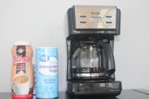 a coffee maker with a coffeemaker and a can of coffee at Minsk Hotels - Extended Stay, I-10 Tucson Airport in Tucson