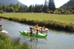 a group of people riding on tubes in a river at Ferienhof Zum Sagschneider in Lenggries