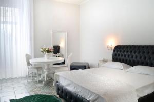 a bedroom with a bed and a table and a mirror at Barbarella Home in Naples
