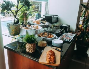 a buffet with bread and pastries on a counter at Hotel Boulevard in Lima
