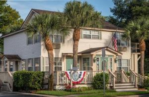 a house with palm trees in front of it at The Cozy Inn in Saint Augustine