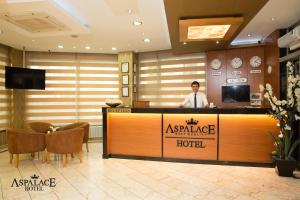 a man standing at a hotel counter in a hotel lobby at Aspalace Hotel The Istanbul Old City in Istanbul