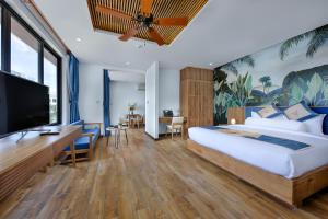 a bedroom with a large bed and a flat screen tv at Animor Green Home Villa Da Nang in Da Nang