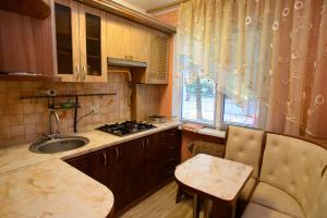 a small kitchen with a sink and a stove at Апартаменты Deluxe in Cherkasy