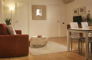 a living room with a couch and a table at Palazzo Moncada Apartment in Palermo
