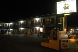 a large building with a sign on the side of it at John Day Motel in John Day