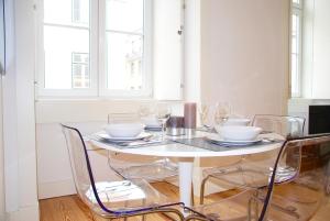 リスボンにあるDowntown Sunny Apartmentの白いテーブル(椅子、ボウル、グラス付)
