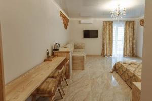 a living room with a table and a couch at Бутик 2017 in Bilhorod-Dnistrovskyi