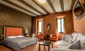 a bedroom with a bed and a couch at Vanilla Hotel in Lublin