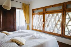 two beds in a room with a window at Casa Montecuccoli in Montelupo Fiorentino