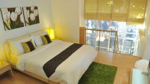 a bedroom with a large bed and a window at Duplex 21 Apartment in Bangkok +37 photos
