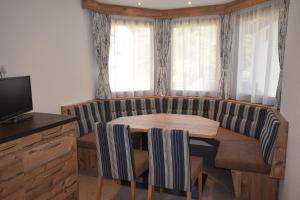 een eetkamer met een houten tafel en stoelen bij Haus Romana in Sölden