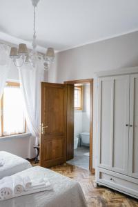 a bedroom with a bed and a chandelier at Casa Montecuccoli in Montelupo Fiorentino