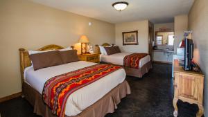 a hotel room with two beds and a television at NRS Event Center & Guest Ranch in Decatur