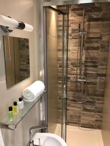 a bathroom with a shower with a sink and a mirror at Glaisdale Studios in Wolverhampton