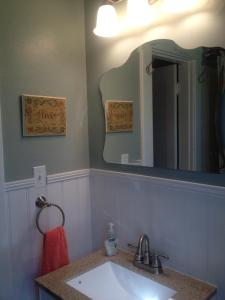 a bathroom with a sink and a mirror at Charming home in Derby city in Louisville