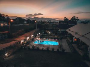 an overhead view of a swimming pool at night at Noah Rosa Chalés in Praia do Rosa