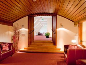 a lobby with stairs and a wooden ceiling at ACHAT Hotel Regensburg Herzog am Dom in Regensburg