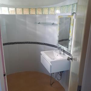 a white bathroom with a sink and a mirror at Sunrise Beach Resort in Ko Chang