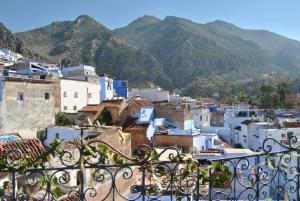 a view of a town with mountains in the background at Casa La Hiba in Chefchaouene