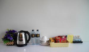 a counter with a coffee maker and bottles of water at Gypsy Sea View Resort in Phi Phi Don