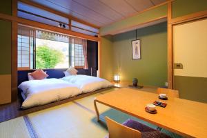 a bedroom with a bed and a table in it at Meitoya So in Zao Onsen