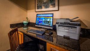 a desk with a computer and a printer on it at Best Western Adams Inn Quincy-Boston in Quincy