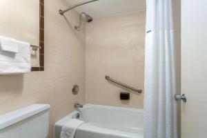 a bathroom with a white tub and a shower at Days Inn by Wyndham Breezewood in Breezewood