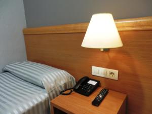 Postel nebo postele na pokoji v ubytování Hotel Inglés