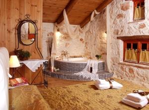 a large bathroom with a tub and a sink at Revera Traditional Stone Villas, Apartments & Studios in Keri +47 photos