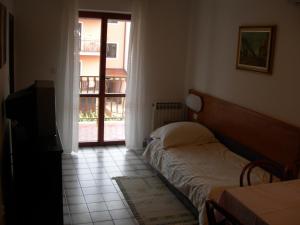 Postel nebo postele na pokoji v ubytování Apartments Nadija