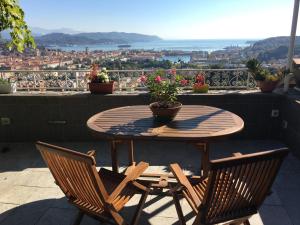 a table and chairs on a balcony with a view at 88 Miglia in La Spezia