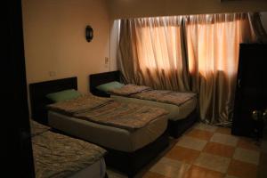 A bed or beds in a room at Wake Up! Cairo Hostel