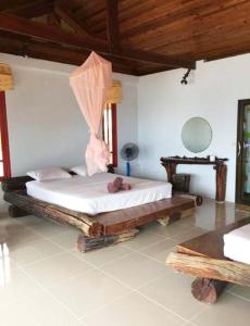 a bedroom with a bed in a room at Mountain Reef Beach Resort in Koh Tao