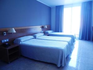 Postel nebo postele na pokoji v ubytování Hotel Inglés