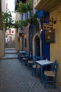 a row of tables and chairs outside of a restaurant at Nostos Hotel in Chania Town