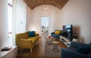 a living room with two couches and a tv at Villa Santadi in Santadi