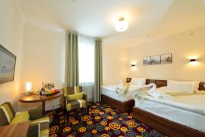 Łóżko lub łóżka w pokoju w obiekcie Konfor Hotel Burabay
