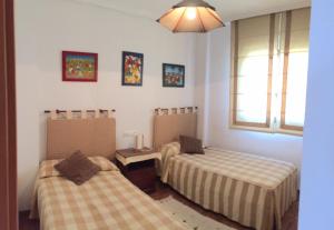 A bed or beds in a room at Playa Paraiso 27A