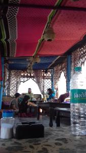 a group of people sitting at a table with a water bottle at Hotel Poonam Pushkar in Pushkar